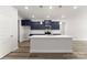 Modern kitchen featuring a large island with white countertops and navy cabinetry at 1469 Mocksville Hwy # 21, Statesville, NC 28625