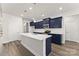 Modern kitchen featuring navy blue cabinetry, stainless steel appliances, and a large white center island at 1469 Mocksville Hwy # 21, Statesville, NC 28625