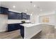 Modern kitchen with navy cabinets, stainless steel appliances, and a quartz island at 1469 Mocksville Hwy # 21, Statesville, NC 28625