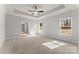 Spacious main bedroom features a ceiling fan, a tray ceiling, and carpeted floors for added comfort at 1469 Mocksville Hwy # 21, Statesville, NC 28625