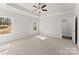 Main bedroom features tray ceiling, ceiling fan, carpet flooring and natural light at 1469 Mocksville Hwy # 21, Statesville, NC 28625