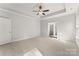 Main bedroom features tray ceiling, ceiling fan, carpet flooring and an ensuite bathroom at 1469 Mocksville Hwy # 21, Statesville, NC 28625