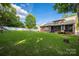 Expansive backyard featuring a well-maintained lawn, screened porch, and partial fencing at 15024 Old Vermillion Dr, Huntersville, NC 28078