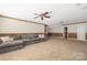 Expansive basement featuring a sectional sofa, wainscotting, plenty of light and versatile layout for various activities at 15024 Old Vermillion Dr, Huntersville, NC 28078