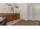 Bathroom with a tub, tiled floors, and double sink vanity at 15024 Old Vermillion Dr, Huntersville, NC 28078