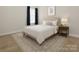 Cozy bedroom featuring neutral decor, soft carpet, and ample natural light from the window with dark blue curtains at 15024 Old Vermillion Dr, Huntersville, NC 28078