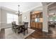 Bright dining room with hardwood floors, a chandelier, and built-in cabinetry at 15024 Old Vermillion Dr, Huntersville, NC 28078