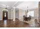 Elegant dining room featuring hardwood floors, a chandelier, and a large window at 15024 Old Vermillion Dr, Huntersville, NC 28078