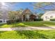 Beautiful home featuring a well-manicured lawn, brick facade, and lush landscaping at 15024 Old Vermillion Dr, Huntersville, NC 28078