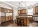 Stylish kitchen with granite countertops, stainless steel appliances, and dark wood cabinets at 15024 Old Vermillion Dr, Huntersville, NC 28078