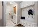 Functional mudroom/laundry area with washer, dryer, storage bench, and cabinets, offering convenience and organization at 15024 Old Vermillion Dr, Huntersville, NC 28078