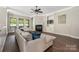 Bright living room with fireplace, ceiling fan, and hardwood floors at 15024 Old Vermillion Dr, Huntersville, NC 28078