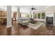Open concept living room and kitchen with hardwood floors and stainless steel appliances at 15024 Old Vermillion Dr, Huntersville, NC 28078
