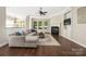 Spacious living room featuring a fireplace, hardwood floors, and ample natural light at 15024 Old Vermillion Dr, Huntersville, NC 28078