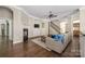 Cozy living room with hardwood floors, fireplace, and staircase at 15024 Old Vermillion Dr, Huntersville, NC 28078