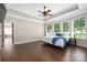 Tranquil main bedroom featuring a tray ceiling, hardwood floors, and lots of natural light at 15024 Old Vermillion Dr, Huntersville, NC 28078