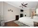 Bright main bedroom features hardwood floors, ceiling fan, and a cozy fireplace for comfort and style at 15024 Old Vermillion Dr, Huntersville, NC 28078