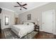Inviting main bedroom boasts hardwood floors, ceiling fan and classic decor for a tranquil and stylish retreat at 15024 Old Vermillion Dr, Huntersville, NC 28078