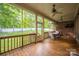 Relaxing screened porch with ceiling fans, wood floors, and a view of the backyard at 15024 Old Vermillion Dr, Huntersville, NC 28078