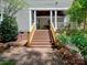 Beautiful backyard with wooden stairs leading to a covered porch with a garden at 15323 Barnsbury Dr, Huntersville, NC 28078