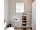 Neutral bathroom with traditional fixtures, shiplap accent wall, and decorative storage at 15323 Barnsbury Dr, Huntersville, NC 28078