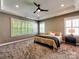 Calm bedroom with tray ceilings, large windows, and neutral tones at 15323 Barnsbury Dr, Huntersville, NC 28078
