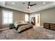 Neutral bedroom with tray ceiling, large windows, carpet and ensuite bathroom at 15323 Barnsbury Dr, Huntersville, NC 28078