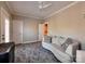 Cozy bedroom with neutral walls, plush carpeting, and a stylish curved sofa at 15323 Barnsbury Dr, Huntersville, NC 28078