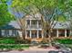 Front view of the community clubhouse with stone accents and a landscaped lawn at 15323 Barnsbury Dr, Huntersville, NC 28078