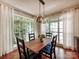 Light filled dining area with large windows and modern chandelier at 15323 Barnsbury Dr, Huntersville, NC 28078