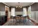 Stylish dining room featuring modern lighting, elegant curtains, and wainscoting details at 15323 Barnsbury Dr, Huntersville, NC 28078