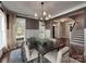 Well-lit dining room showcasing wainscoting, stylish curtains, and hardwood floors at 15323 Barnsbury Dr, Huntersville, NC 28078