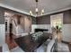 Spacious dining room with hardwood floors, modern chandelier, and easy access to other areas at 15323 Barnsbury Dr, Huntersville, NC 28078
