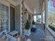 Welcoming front porch featuring a porch swing, rope accent, and potted greenery at 15323 Barnsbury Dr, Huntersville, NC 28078