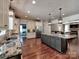 Spacious open kitchen with large island featuring granite counters and stainless steel appliances at 15323 Barnsbury Dr, Huntersville, NC 28078
