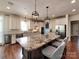 Open kitchen features a large center island with granite countertops and pendant lighting at 15323 Barnsbury Dr, Huntersville, NC 28078