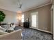 Bright living room with comfortable seating, a modern ceiling fan, and a minimalist decor at 15323 Barnsbury Dr, Huntersville, NC 28078