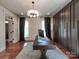 Inviting home office featuring hardwood floors, a decorative rug, and plenty of natural light at 15323 Barnsbury Dr, Huntersville, NC 28078