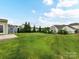 Sprawling backyard featuring lush lawn, trees and black metal fencing at 15747 Reynolds Dr, Indian Land, SC 29707
