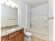 Clean bathroom featuring a granite vanity, neutral tile, and a shower-tub combination, ideal for relaxation at 15747 Reynolds Dr, Indian Land, SC 29707