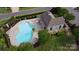 Aerial view of a community pool featuring lounge chairs, a covered area and lush landscaping for a serene atmosphere at 15747 Reynolds Dr, Indian Land, SC 29707