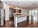 Bright kitchen with an island, stainless steel appliances, and dark wood cabinets at 15747 Reynolds Dr, Indian Land, SC 29707
