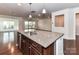 Kitchen island with granite countertop, sink, and stainless steel dishwasher at 15747 Reynolds Dr, Indian Land, SC 29707