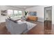 Comfortable living room with modern furnishings, hardwood floors, and a large window offering serene views at 15747 Reynolds Dr, Indian Land, SC 29707