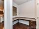 Home office space with granite countertop desk and dark wood drawers at 15747 Reynolds Dr, Indian Land, SC 29707