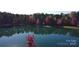 Scenic view of a serene pond reflecting the surrounding trees and sky, creating a peaceful and natural environment at 15747 Reynolds Dr, Indian Land, SC 29707