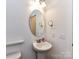 Powder room featuring a pedestal sink and an oval mirror at 15747 Reynolds Dr, Indian Land, SC 29707