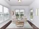Bright sunroom with cozy seating, natural light, and a relaxing ambiance perfect for leisure and enjoyment at 15747 Reynolds Dr, Indian Land, SC 29707