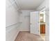 Walk-in closet with installed shelving and access to the en-suite bathroom at 15747 Reynolds Dr, Indian Land, SC 29707