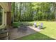 Spacious backyard with a patio and seating area surrounded by lush trees, creating a peaceful outdoor retreat at 1730 Deer St, Charlotte, NC 28214